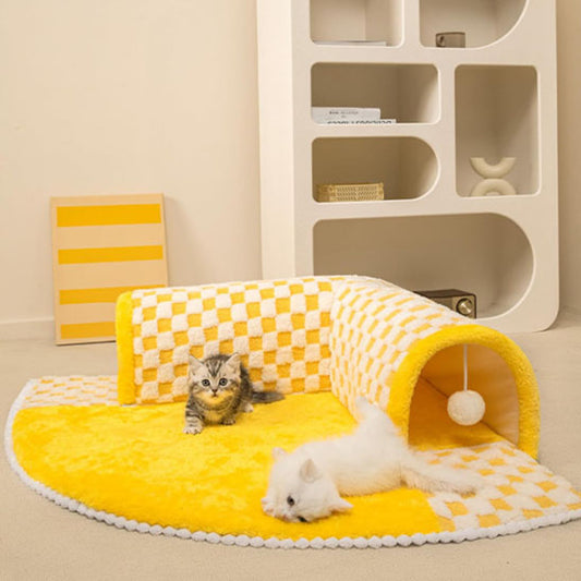 Niche pour chaton tunnel à carreaux jaune et blanc et une balle en peluche suspendue et deux chatons gris et blanc qui jouent sur le tapis de cette niche.